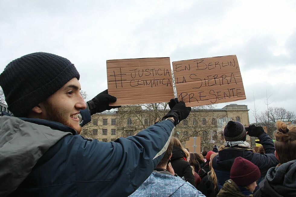 Felipe Alberto Corral Montoya at the Global Strike for Future in Berlin holding sign in solidarity with the community of La Sierra in Colombia, where a local protest was taking place, 15 March 2019.  Photo by José Imer Campos